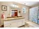 Bathroom featuring double vanity with granite countertop, walk in shower, and tile flooring at 206 Lisa Dr, Carrboro, NC 27510