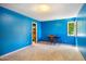 Bright blue bedroom with a walk-in closet, a window, and neutral carpet, perfect for relaxing at 206 Lisa Dr, Carrboro, NC 27510