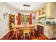 Bright dining area showcasing wood floors, natural light, and a cozy eat-in space near the kitchen at 206 Lisa Dr, Carrboro, NC 27510