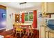 Cozy dining room features wood floors, a bright window, and a charming table with colorful chairs at 206 Lisa Dr, Carrboro, NC 27510