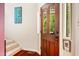Inviting entryway with a dark wooden door and sidelight, complemented by warm hardwood flooring at 206 Lisa Dr, Carrboro, NC 27510