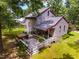 Exterior of home features an outdoor deck with string lights, hot tub, and luscious lawn at 206 Lisa Dr, Carrboro, NC 27510