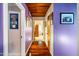 Hallway features hardwood flooring and artistic purple walls, leading to other areas of the home at 206 Lisa Dr, Carrboro, NC 27510