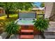 Relaxing hot tub nestled on a wooden deck surrounded by lush greenery and ferns in a private backyard setting at 206 Lisa Dr, Carrboro, NC 27510