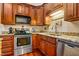 Modern kitchen with stainless steel appliances, granite counters, wood cabinets, and hardwood floors at 206 Lisa Dr, Carrboro, NC 27510