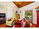 Comfortable living room featuring hardwood floors, wood ceilings, natural light, and seamless access to the outdoor patio at 206 Lisa Dr, Carrboro, NC 27510