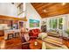 Inviting living room with vaulted wood ceiling, hardwood floors, large windows, and open-concept design at 206 Lisa Dr, Carrboro, NC 27510