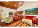 Open-concept living room with hardwood floors, wood ceilings, seamless flow to kitchen, and ample natural light at 206 Lisa Dr, Carrboro, NC 27510