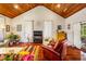 Stylish living room with wood ceiling, hardwood floors, and access to a private back yard at 206 Lisa Dr, Carrboro, NC 27510