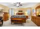 Comfortable main bedroom featuring wood furniture, a ceiling fan, and plenty of natural light at 206 Lisa Dr, Carrboro, NC 27510