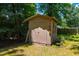 A spacious, well-maintained outbuilding offering extra storage in a verdant yard with mature trees at 206 Lisa Dr, Carrboro, NC 27510
