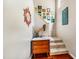 Bright staircase featuring white walls adorned with colorful artwork, with hardwood and carpet flooring at 206 Lisa Dr, Carrboro, NC 27510