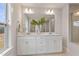 Bright bathroom with a double sink vanity, large mirror, and modern lighting fixtures at 21 Whistling Way # 17, Lillington, NC 27546