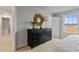 Bright bedroom featuring a stylish black dresser, gold mirror, and natural light from the window at 21 Whistling Way # 17, Lillington, NC 27546