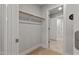 Walk-in closet features a wooden shelf with a hanging rod, carpet flooring, and white trim at 21 Whistling Way # 17, Lillington, NC 27546