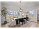 Bright dining room features large windows, modern chandelier, wood table, and stylish rug at 21 Whistling Way # 17, Lillington, NC 27546