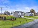 New construction home with manicured lawn and landscaping in a modern residential neighborhood at 21 Whistling Way # 17, Lillington, NC 27546