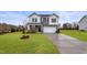 Charming two-story home with gray and white siding, a two-car garage, and a manicured lawn at 21 Whistling Way # 17, Lillington, NC 27546