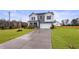 Charming two-story home with gray and white siding, a two-car garage, and a manicured lawn at 21 Whistling Way # 17, Lillington, NC 27546