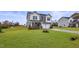 Charming two-story home with gray and white siding, a two-car garage, and a manicured lawn at 21 Whistling Way # 17, Lillington, NC 27546