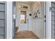 Bright foyer with white wainscoting, a glass-paneled door, and luxury vinyl plank flooring at 21 Whistling Way # 17, Lillington, NC 27546