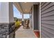 Inviting front porch featuring rocking chairs and stone-based support columns on this modern home at 21 Whistling Way # 17, Lillington, NC 27546