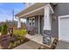 Charming front porch with rocking chairs and stone accents on the columns of this new construction home at 21 Whistling Way # 17, Lillington, NC 27546