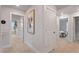 Hallway with neutral carpet, white walls, and doorways leading to bedrooms and living spaces at 21 Whistling Way # 17, Lillington, NC 27546