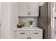 Kitchen features white shaker cabinets, marble backsplash, stainless steel refrigerator and quartz countertops at 21 Whistling Way # 17, Lillington, NC 27546