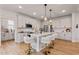 Modern kitchen with white cabinets, a large center island, and stainless steel appliances at 21 Whistling Way # 17, Lillington, NC 27546