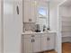 Cozy kitchenette featuring white cabinets, a sink with faucet, and entry to a pantry at 21 Whistling Way # 17, Lillington, NC 27546