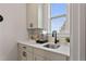 Cozy kitchenette featuring white cabinets, a sink with faucet, and a window with natural light at 21 Whistling Way # 17, Lillington, NC 27546