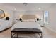 Main bedroom with upholstered headboard, bench, side tables, lamps, and a window at 21 Whistling Way # 17, Lillington, NC 27546