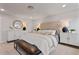 Main bedroom with upholstered headboard, bench, side tables, lamps, and a window at 21 Whistling Way # 17, Lillington, NC 27546