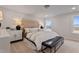 Main bedroom with upholstered headboard, bench, side tables, lamps, and a window at 21 Whistling Way # 17, Lillington, NC 27546