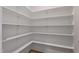 Walk-in pantry with built in shelving and a white interior at 21 Whistling Way # 17, Lillington, NC 27546