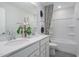 This bathroom features a double sink vanity with white cabinets, an oversized mirror and a shower/tub combo at 2301 Edenberry Ln, Fuquay Varina, NC 27526