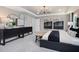This main bedroom features neutral walls, soft carpet, and a tray ceiling with a modern chandelier at 2301 Edenberry Ln, Fuquay Varina, NC 27526
