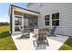 Relaxing backyard patio featuring modern gray Adirondack chairs surrounding a sleek concrete fire pit at 2301 Edenberry Ln, Fuquay Varina, NC 27526