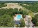 Aerial view of community pool with sun loungers, surrounded by lush greenery at 2626 Nassau Trce, Fuquay Varina, NC 27526