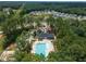 Aerial view of community pool and clubhouse surrounded by mature trees at 2626 Nassau Trce, Fuquay Varina, NC 27526