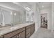 Well-lit bathroom featuring double sinks, granite countertops, and walk-in shower at 2626 Nassau Trce, Fuquay Varina, NC 27526