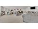 Spacious bonus room with neutral carpet, sectional sofa, and a desk, perfect for hobbies or relaxing at 2626 Nassau Trce, Fuquay Varina, NC 27526