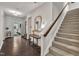 Welcoming foyer with hardwood floors and staircase with a decorative table, mirror, and light fixture at 2626 Nassau Trce, Fuquay Varina, NC 27526
