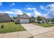 Attractive single-story home with a two-car garage, lush lawn, and American flag on display at 2626 Nassau Trce, Fuquay Varina, NC 27526