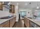 Well-lit kitchen with stainless steel appliances and granite countertops, open to the dining area at 2626 Nassau Trce, Fuquay Varina, NC 27526