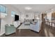 Bright living room featuring modern decor, wood flooring, and an open layout to the kitchen and dining areas at 2626 Nassau Trce, Fuquay Varina, NC 27526