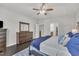Spacious main bedroom with dark hardwood floors, ceiling fan, and ensuite bath and walk-in closet at 2626 Nassau Trce, Fuquay Varina, NC 27526