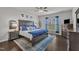 Cozy main bedroom with a large bed, wood floors, and elegant furnishings with plenty of natural light at 2626 Nassau Trce, Fuquay Varina, NC 27526