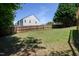 Large backyard features a well-maintained lawn and wooden privacy fence at 2725 Gross Ave, Wake Forest, NC 27587
